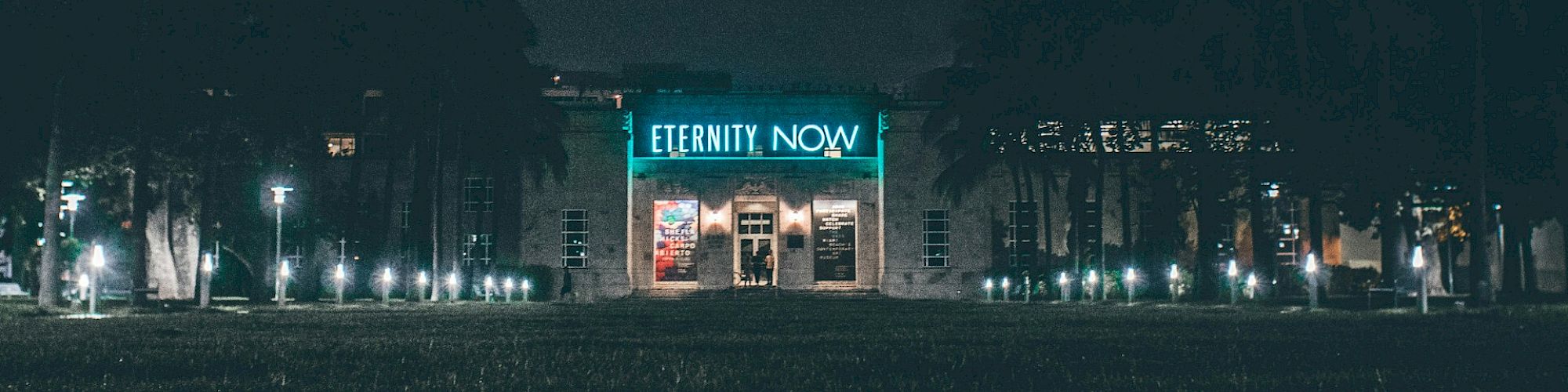 The image shows a building at night with the bright sign 